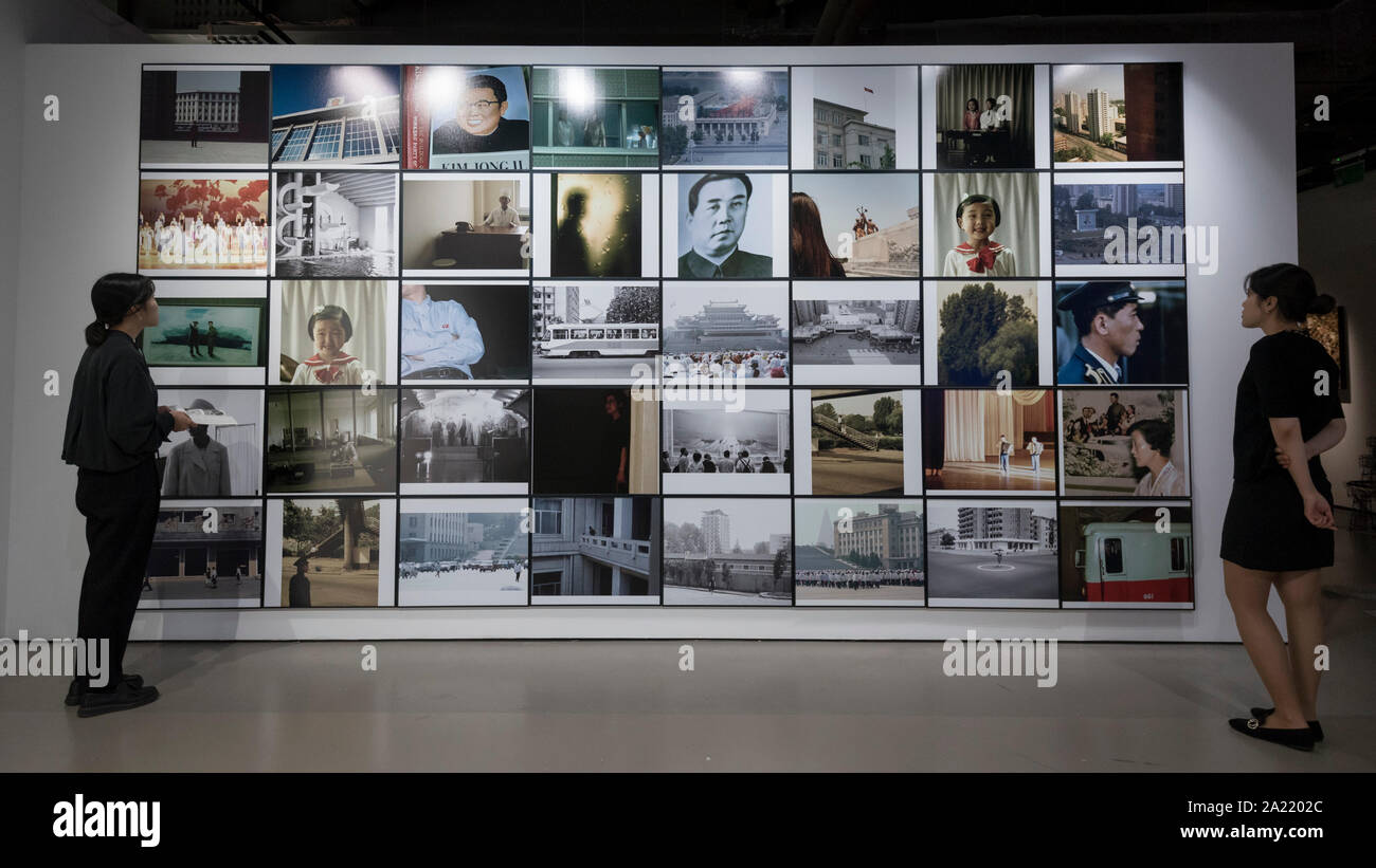 London, UK.  30 September 2019. Staff members view 'Blow Up', 2005-2007, by Seung Woo Back, a 40 piece set of photographs. Preview of 'Negotiating Borders', an exhibition organised by the Real DMZ Project exploring the history and future of the DMZ (Demilitarised Zone), the four kilometre wide invisible military borderline at which North and South Korea face each other.  Works by seven Korean artists is on display at the Korean Cultural Centre UK, 1 October to 23 November 2019.  Credit: Stephen Chung / Alamy Live News Stock Photo