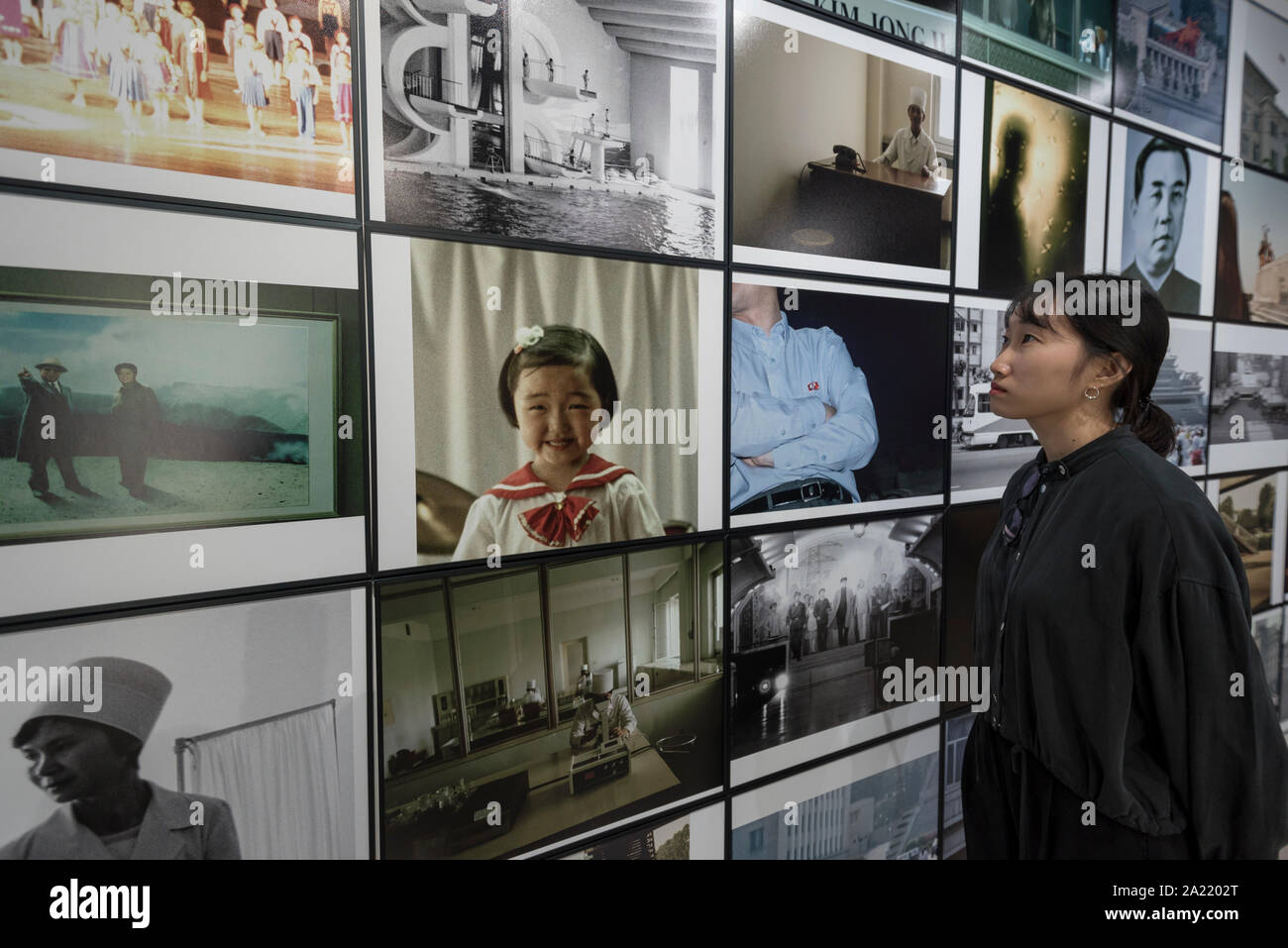 London, UK.  30 September 2019. A staff member views 'Blow Up', 2005-2007, by Seung Woo Back, a 40 piece set of photographs. Preview of 'Negotiating Borders', an exhibition organised by the Real DMZ Project exploring the history and future of the DMZ (Demilitarised Zone), the four kilometre wide invisible military borderline at which North and South Korea face each other.  Works by seven Korean artists is on display at the Korean Cultural Centre UK, 1 October to 23 November 2019.  Credit: Stephen Chung / Alamy Live News Stock Photo