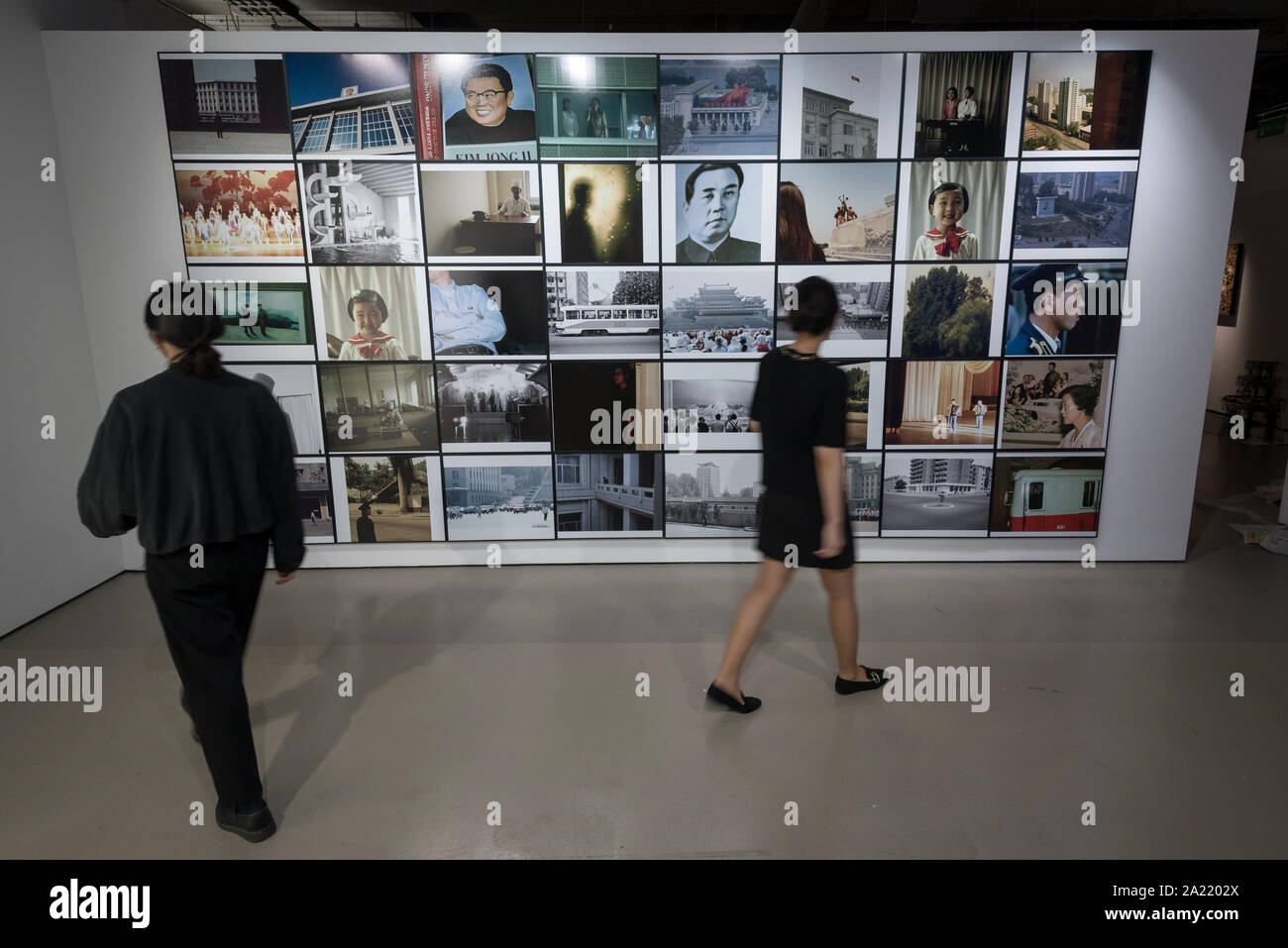 London, UK.  30 September 2019. Staff members view 'Blow Up', 2005-2007, by Seung Woo Back, a 40 piece set of photographs. Preview of 'Negotiating Borders', an exhibition organised by the Real DMZ Project exploring the history and future of the DMZ (Demilitarised Zone), the four kilometre wide invisible military borderline at which North and South Korea face each other.  Works by seven Korean artists is on display at the Korean Cultural Centre UK, 1 October to 23 November 2019.  Credit: Stephen Chung / Alamy Live News Stock Photo