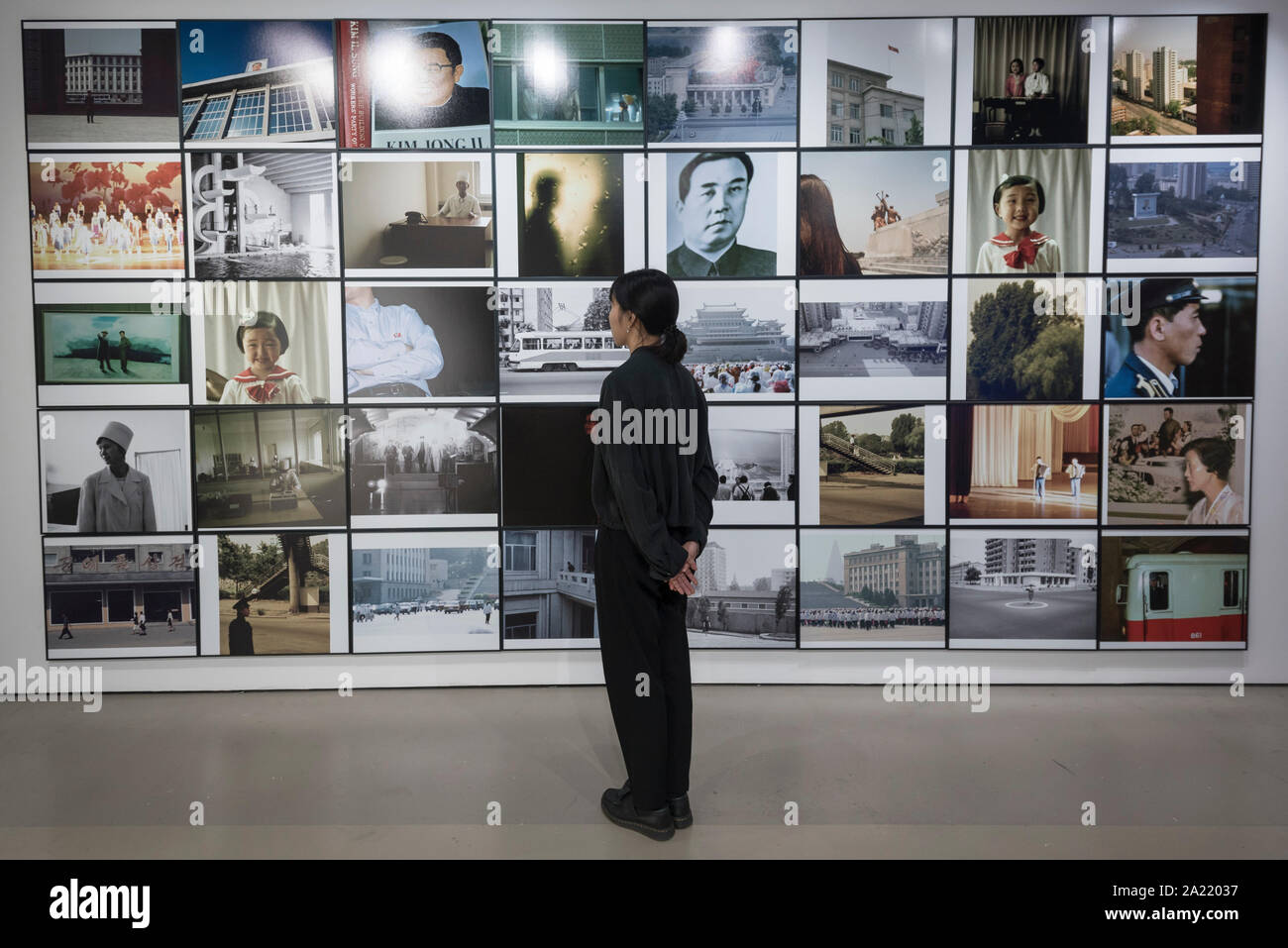 London, UK.  30 September 2019. A staff member views 'Blow Up', 2005-2007, by Seung Woo Back, a 40 piece set of photographs. Preview of 'Negotiating Borders', an exhibition organised by the Real DMZ Project exploring the history and future of the DMZ (Demilitarised Zone), the four kilometre wide invisible military borderline at which North and South Korea face each other.  Works by seven Korean artists is on display at the Korean Cultural Centre UK, 1 October to 23 November 2019.  Credit: Stephen Chung / Alamy Live News Stock Photo