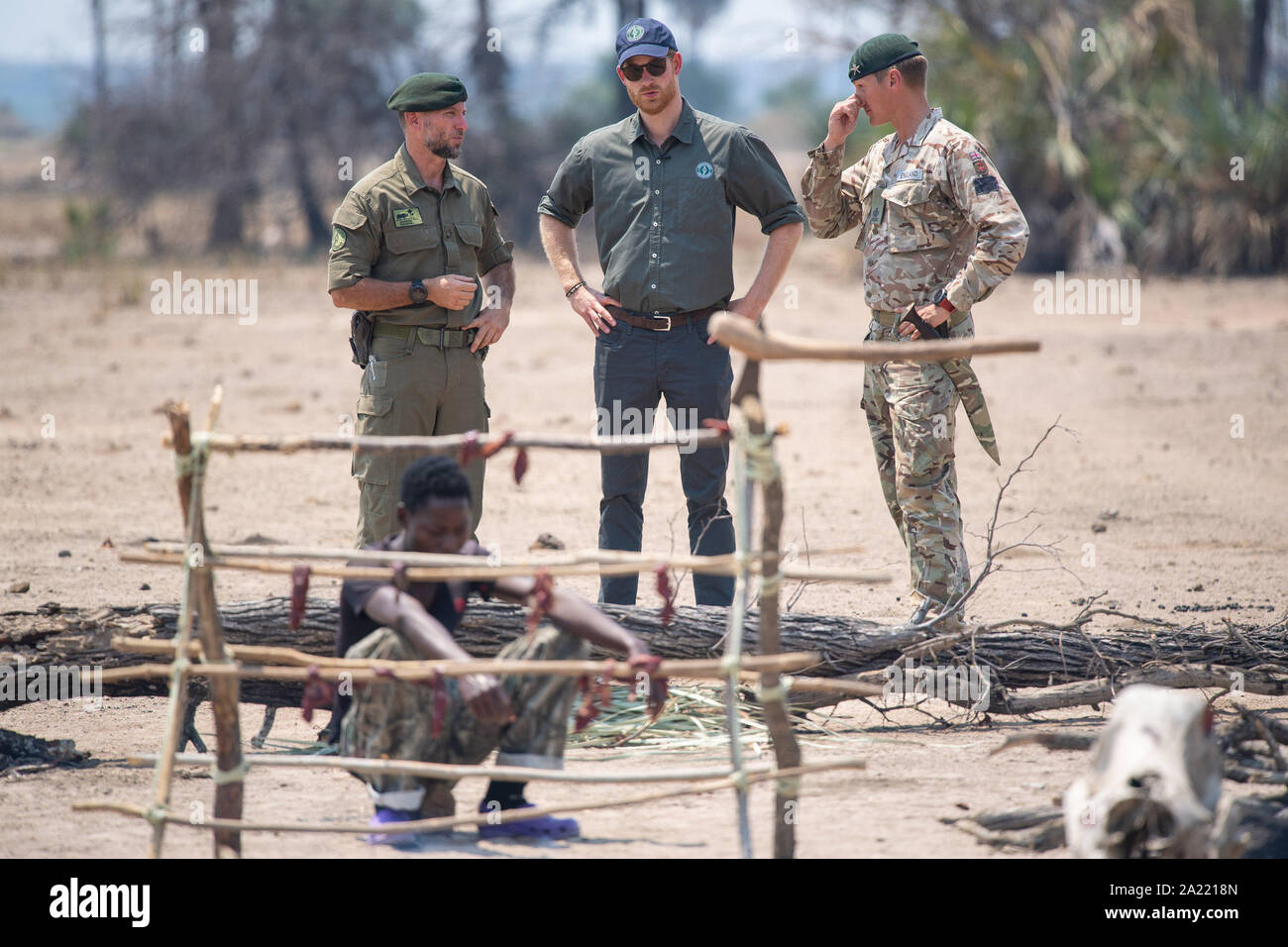 The Duke of Sussex (centre) views a recreation of a poacher's camp, part of an an anti-poaching demonstration exercise conducted jointly by local rangers and UK military, at Liwonde National Park, Malawi, on day eight of the royal tour of Africa. Stock Photo