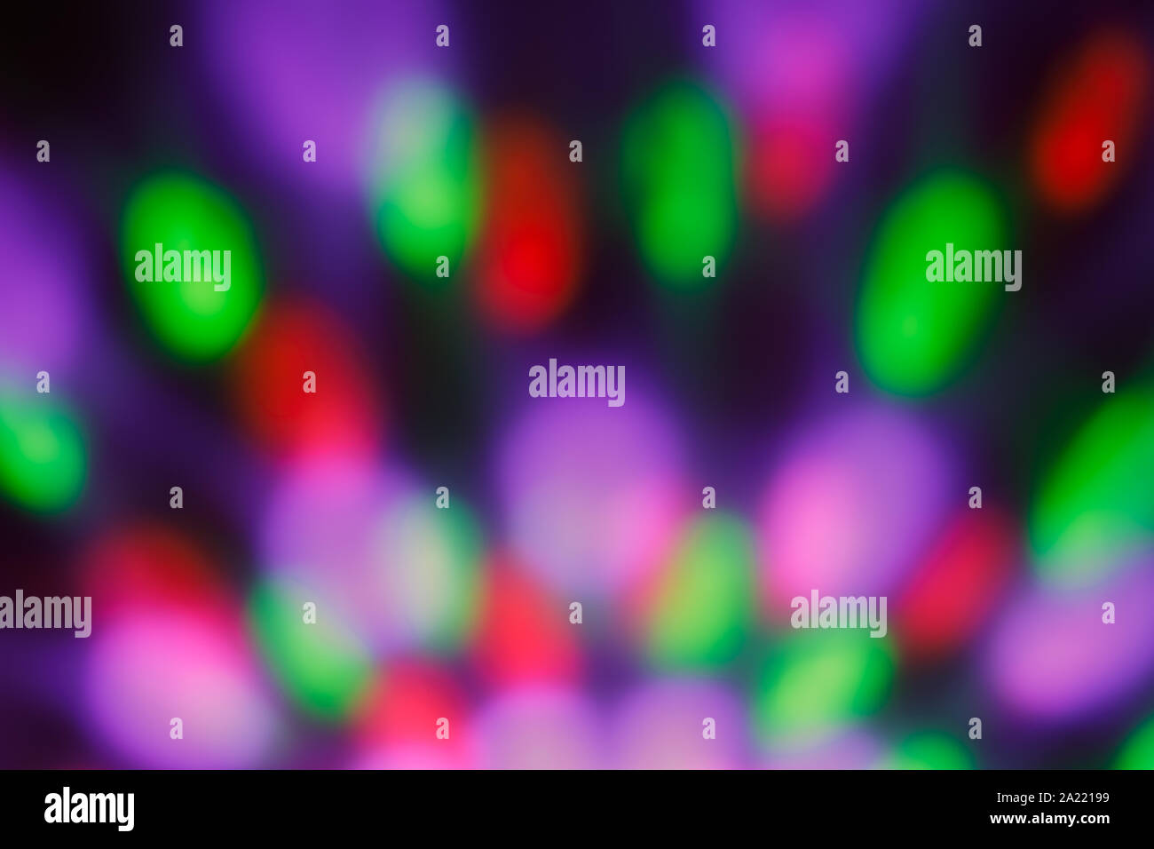 Colorful blurred bokeh with night light. Abstract festive background, pattern. Defocused illuminated dark backdrop. Lights disco backgrounds. Stock Photo