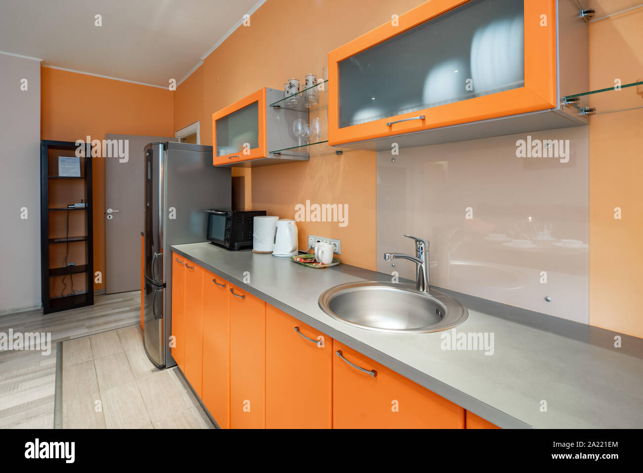 Stylish orange kitchen set. Home appliances Stock Photo Alamy