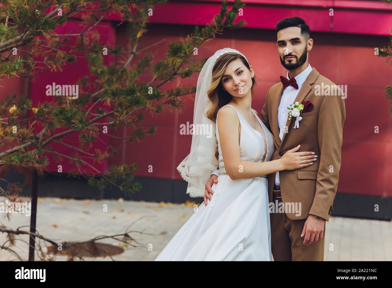 Stylish Happy Bride And Groom Posing At Big Love Word In Evening