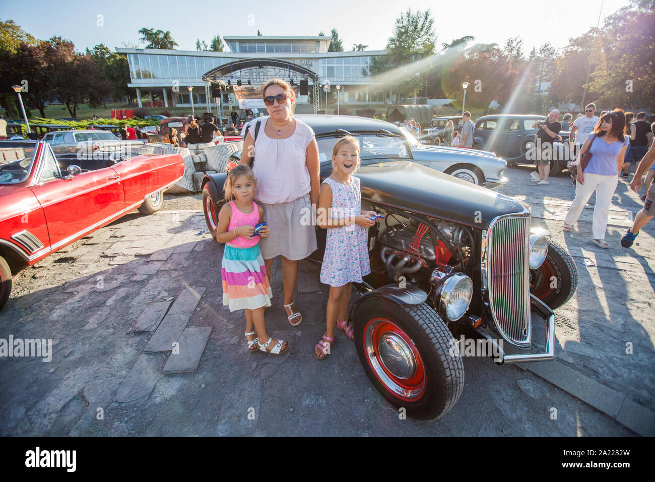 Family Portrait At Old Timer Exhibition Mother And Her Two Daughter At Old Car Show Stock Photo Alamy