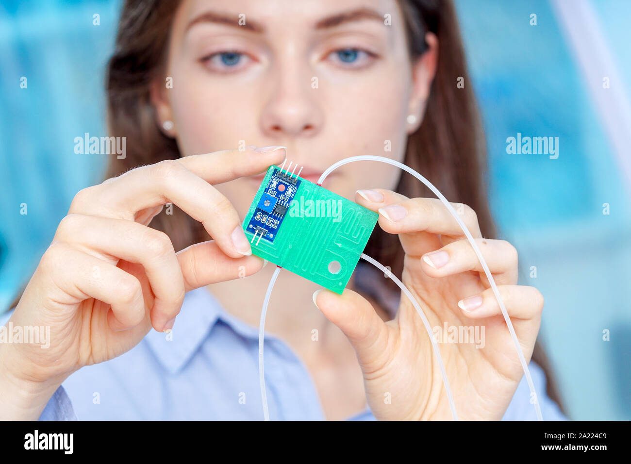 Girl holding polymers BioMEMS biomedical microelectromechanical