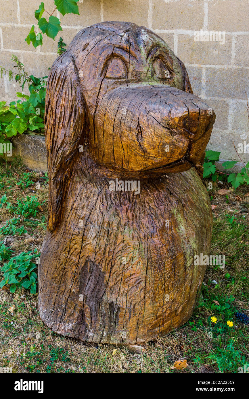 Large lifelike wood carving of dog - Prissac, Indre, France. Stock Photo