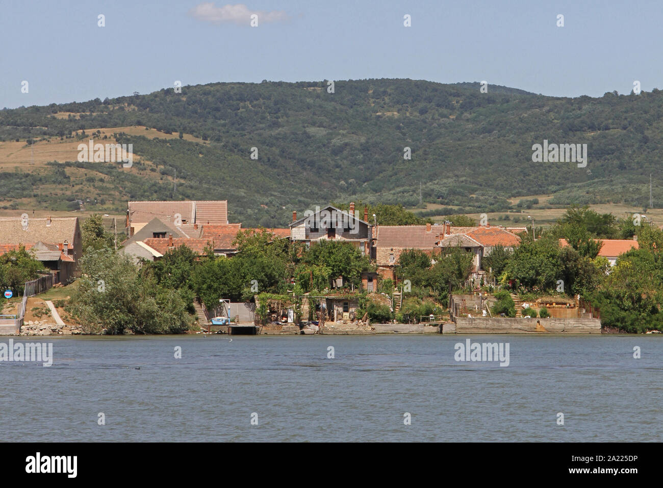 Old houses on the Romanian side of the Danube River seen from Serbia on the border between Romania and Serbia, Moldova Veche, Romania. Stock Photo