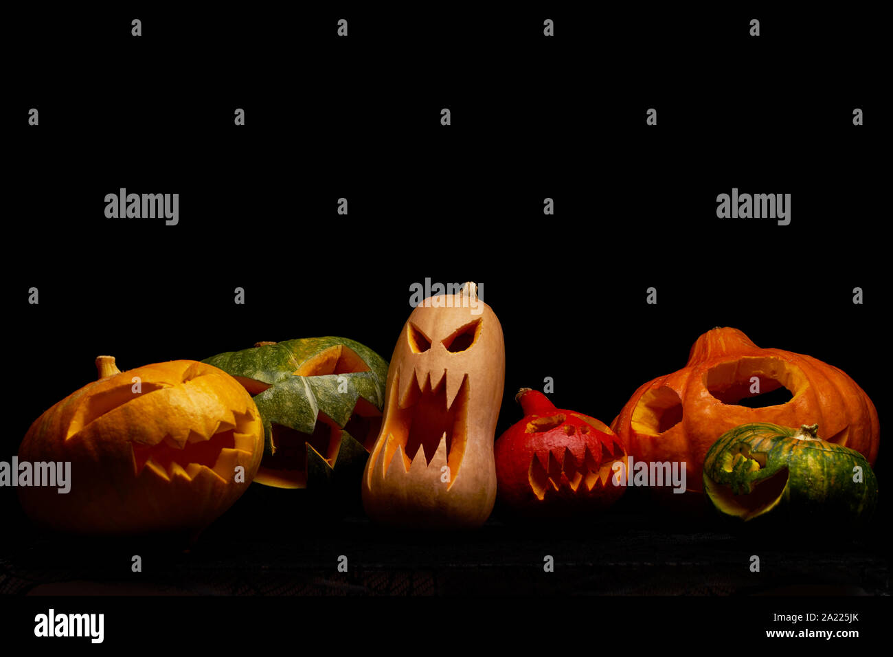 Photo of halloween pumpkins on empty black background in studio Stock Photo