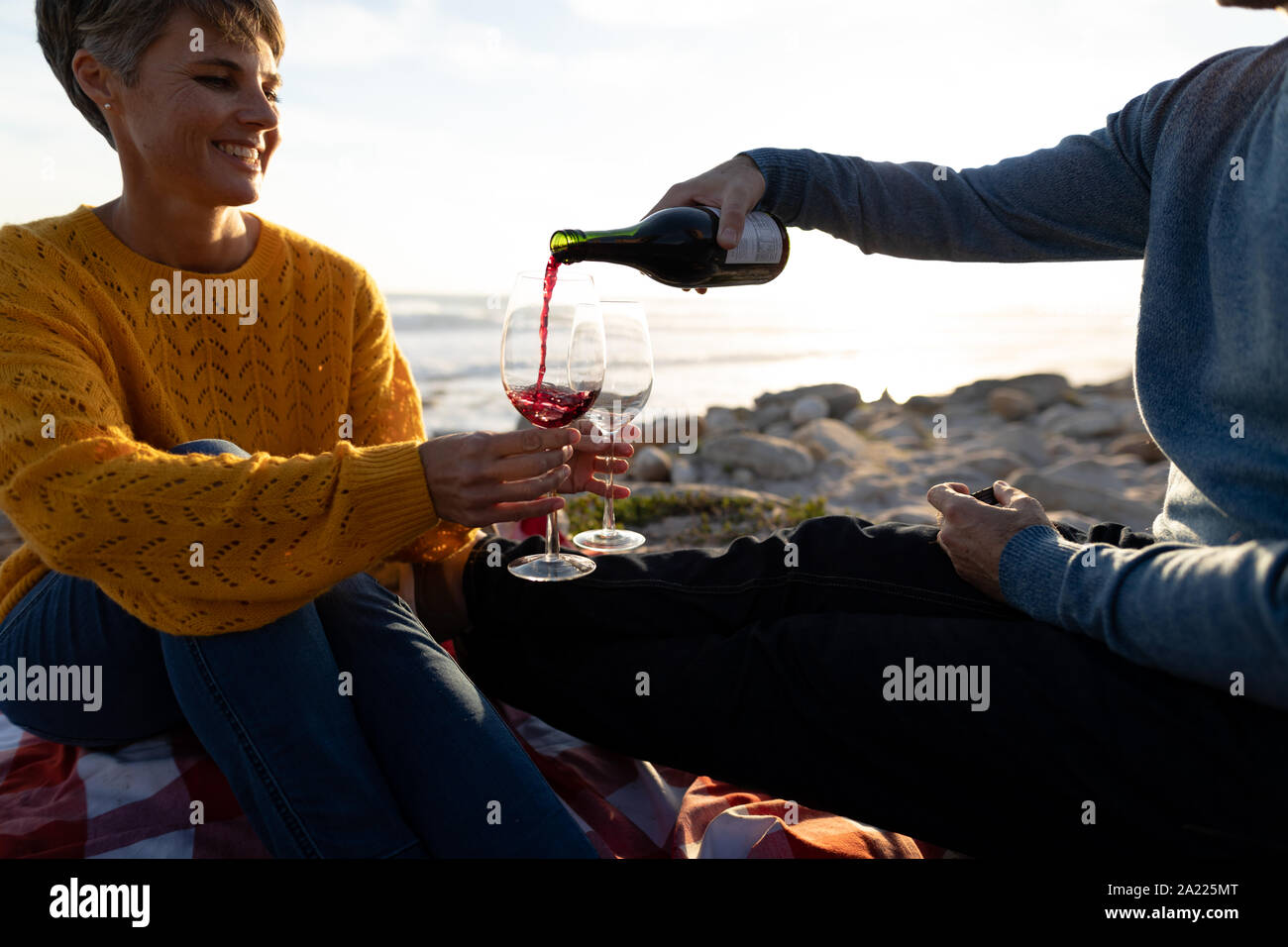 Couple having a picnic by the sea Stock Photo Alamy