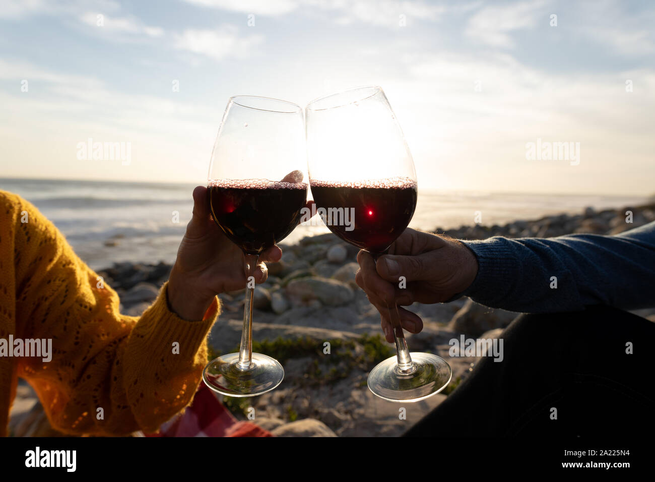 Couple having a picnic by the sea Stock Photo Alamy