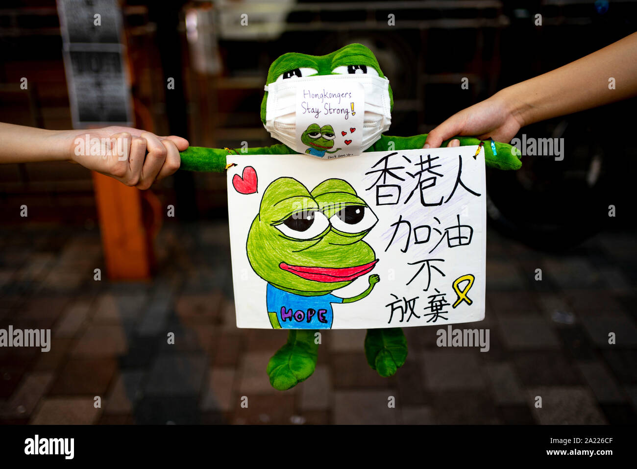 Hong Kong. 30 September, 2019. Peaceful protest held in Tsim Sha Tsui district of Kowloon tonight. Using the frog Pepe, which is a symbol of the pro-democracy movement in the city, protestors formed a human chain stretching along busy Nathan Road.  Iain Masterton/Alamy Live News. Stock Photo