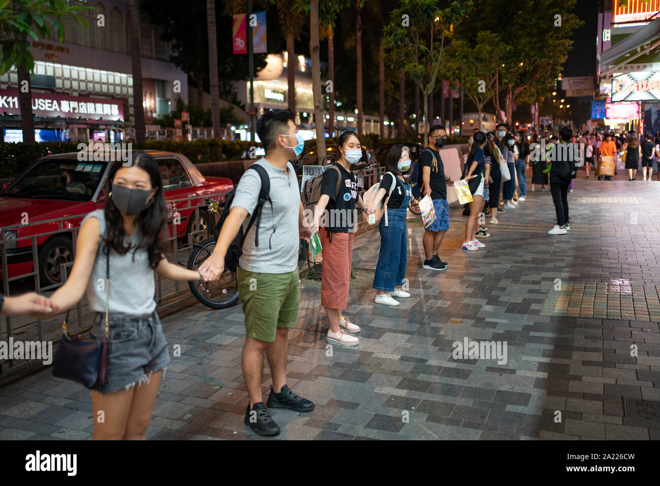 Hong Kong. 30 September, 2019. Peaceful protest held in Tsim Sha Tsui district of Kowloon tonight. Using the frog Pepe, which is a symbol of the pro-democracy movement in the city, protestors formed a human chain stretching along busy Nathan Road.  Iain Masterton/Alamy Live News. Stock Photo
