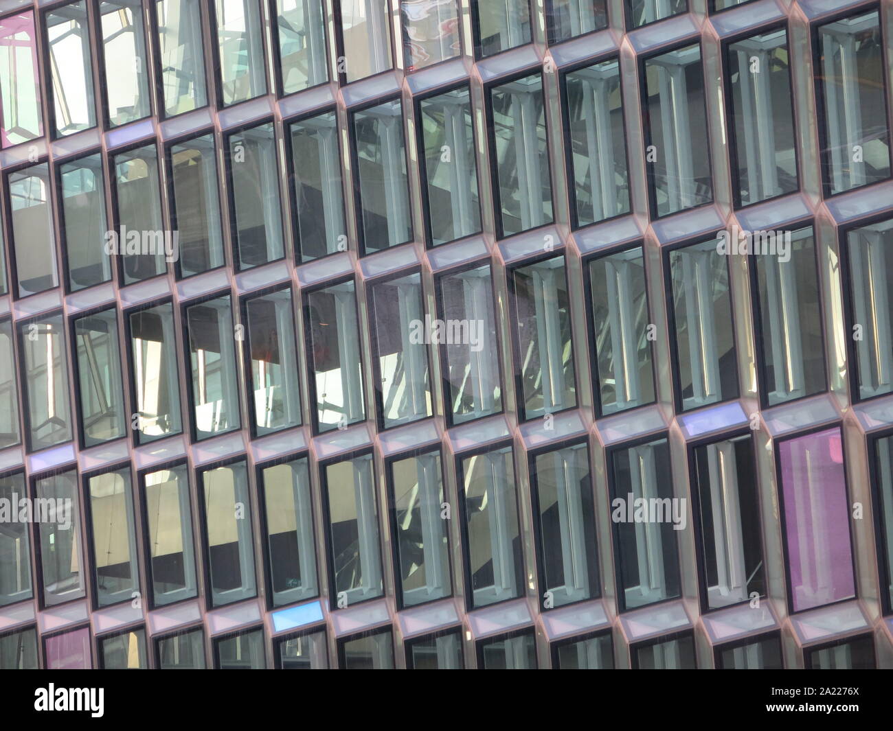 Closeup of rows of coloured glass panels in geometric shapes forming