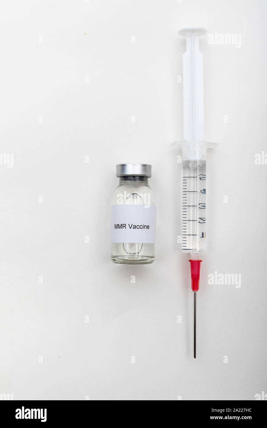 Medical concept showing medical a medical vial reading MMR Vaccine with a syringe Stock Photo