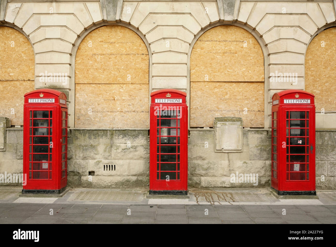 Traditional red telephone boxes outside the disused main Post Office, Blackpool, UK. Stock Photo