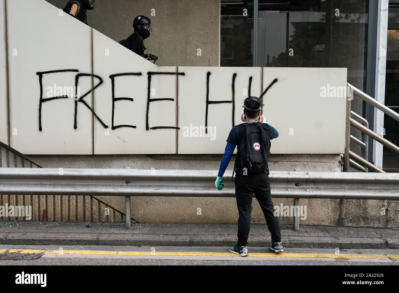 Hong Kong. 29 September, 2019. Illegal march by thousands of pro-democracy supporters from Causeway Bay to Government offices at Admiralty. Police unsuccessfully tried to stop march at start with teargas fired and scuffles. March marked the 5th anniversary of the start of the Umbrella Movement. Graffiti sprayed on wall. Stock Photo