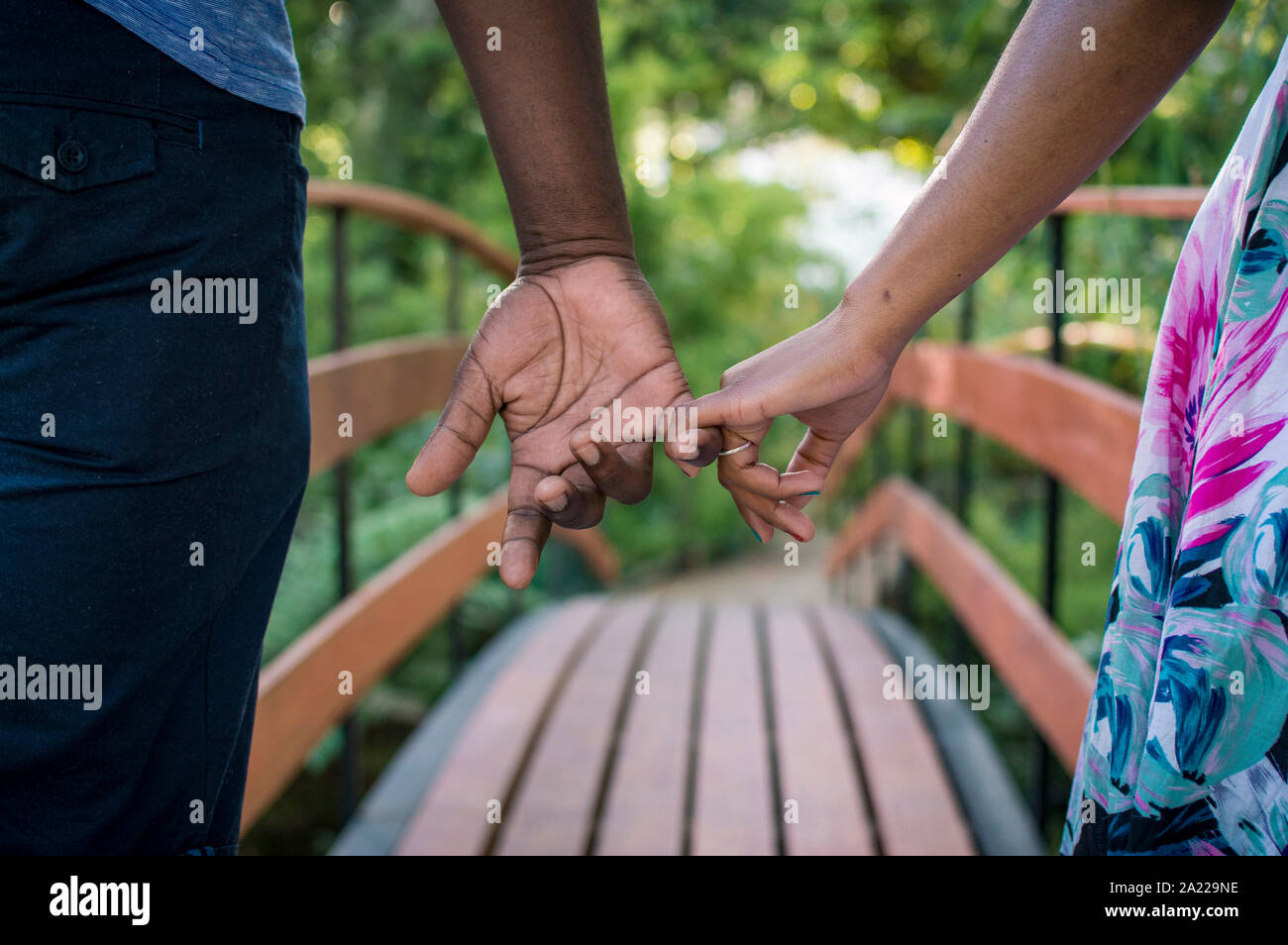 Young couple holding hands in the park Stock Photo