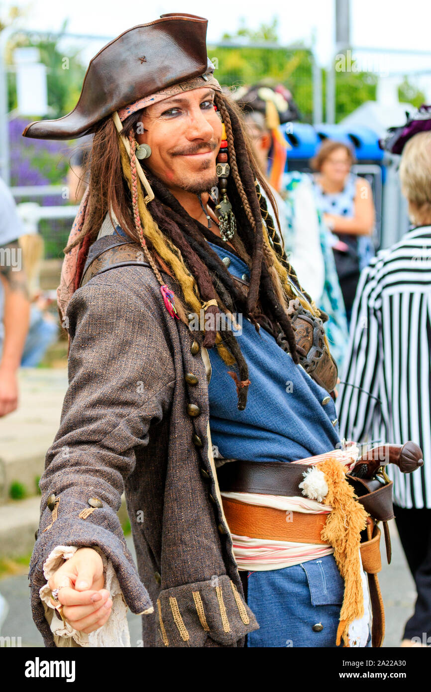 Pirate Day in Hastings, UK. Close up of a smiling young man dressed up as Captain Jack Sparrow. Smiling with head turned to face viewer. Stock Photo