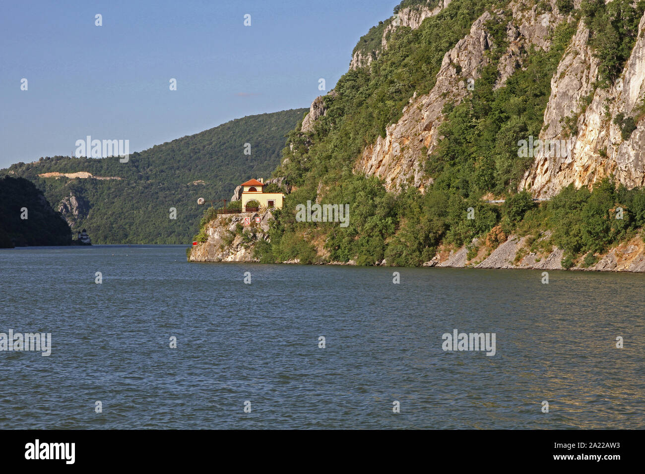 View of train station in Djerdap Gorge and entrance to The Iron Gate and The Great Cauldron on the Danube River, border between Romania and Serbia. Stock Photo