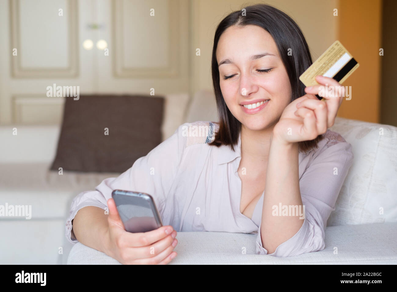 Happy woman shopping and buying online using internet Stock Photo
