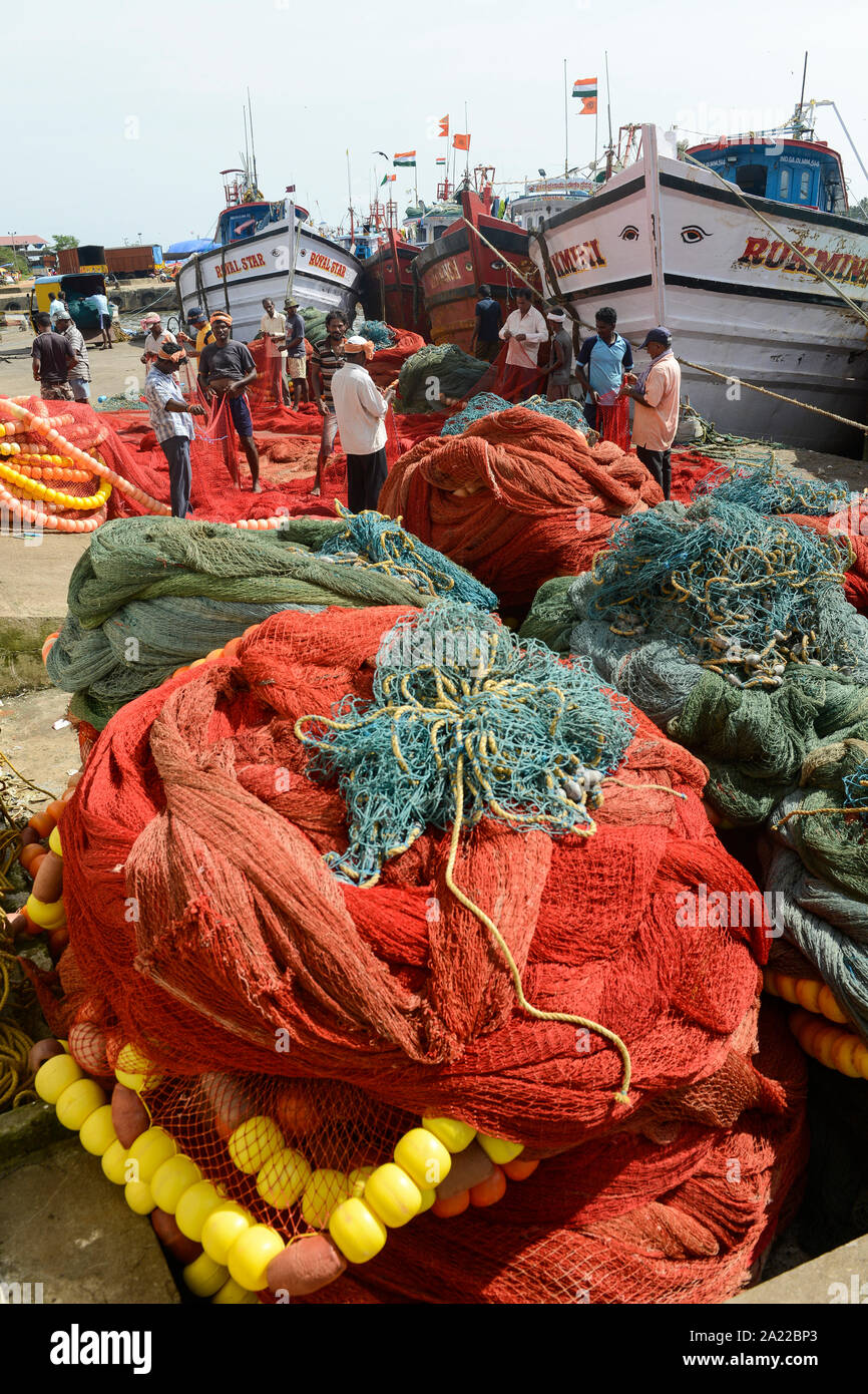 INDIA, Karnataka, Mangaluru, former name Mangalore, trawler in fishing port during monsoon, plastic fishing trawl nets and ropes which are a major source of plastic pollution of the oceans and dangerous for sea animals Stock Photo