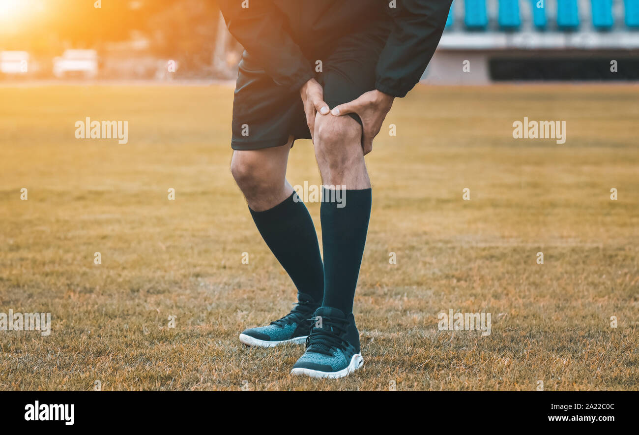 Runner man are Knee pain when Running on Jogging Stock Photo Alamy