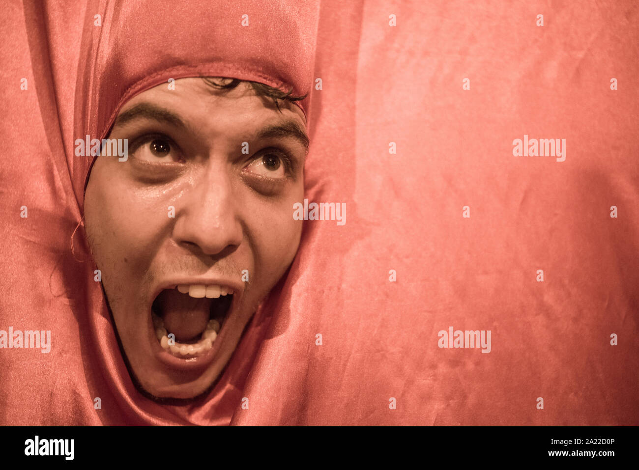 Man yelling wearing reddish carnival costume Stock Photo