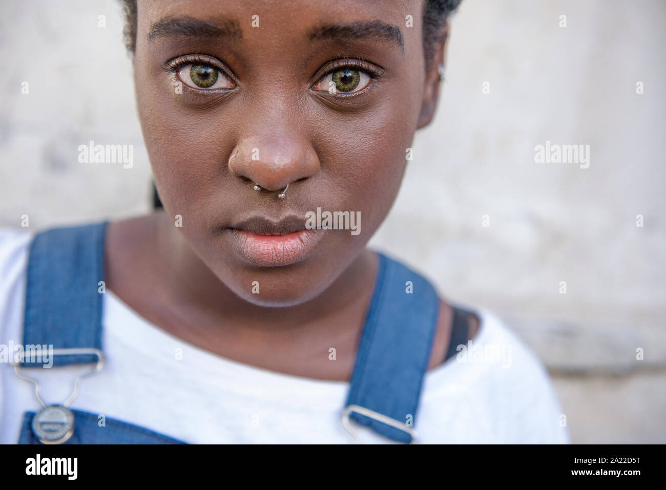 Afro-Brazilian girl with green eyes wearing jumpsuit Stock Photo