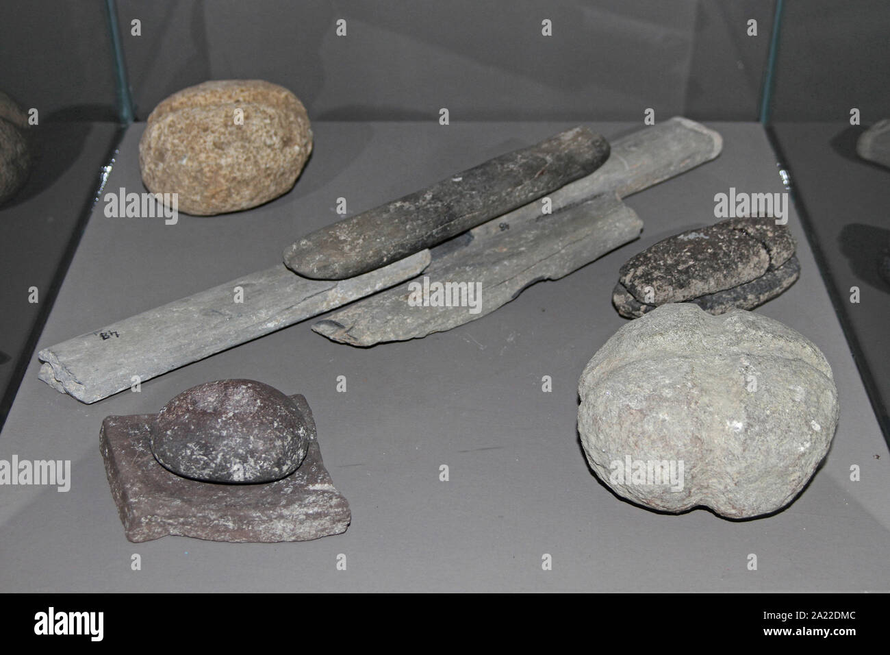Collection ancient prehistoric dug up fossil stone tools, knives, daggers, etc in enclosed glass display at National Archaeological Museum Djerdap, Kladovo, Serbia. Stock Photo