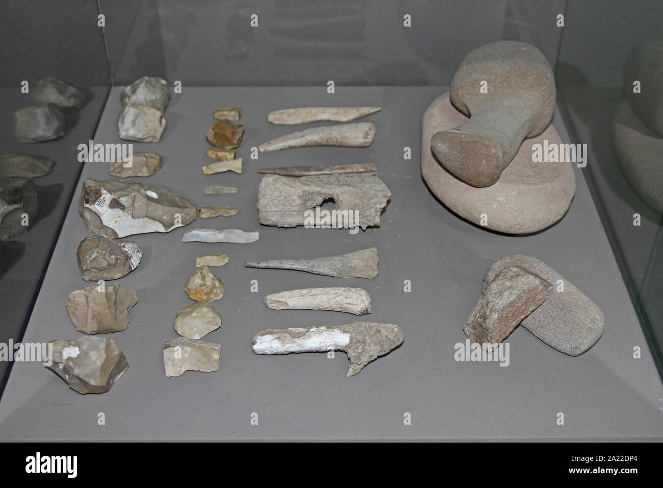 Collection of Ancient prehistoric dug up fossil stone tools, knives, daggers, etc in enclosed glass display at National Archaeological Museum Djerdap, Kladovo, Serbia. Stock Photo