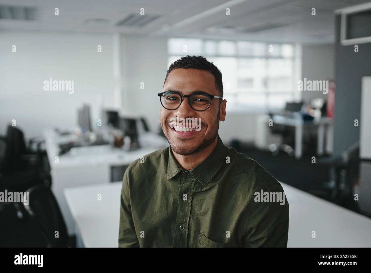 Friendly and smiling young african american professional businessman ...