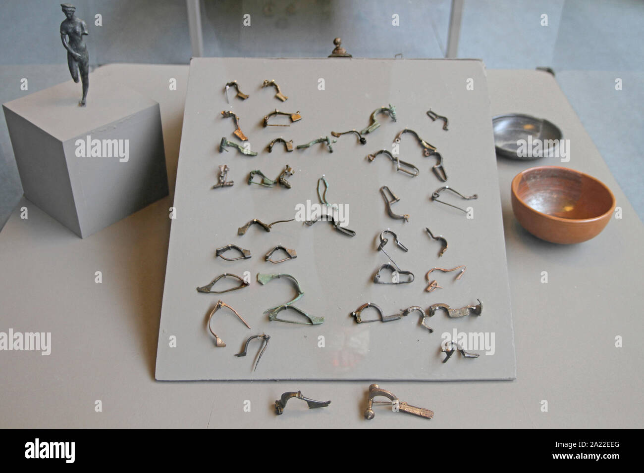 Collection of earrings, chain clips, two bowls and figurine displayed in glass casing, National Archaeological Museum Djerdap, Kladovo, Serbia. Stock Photo