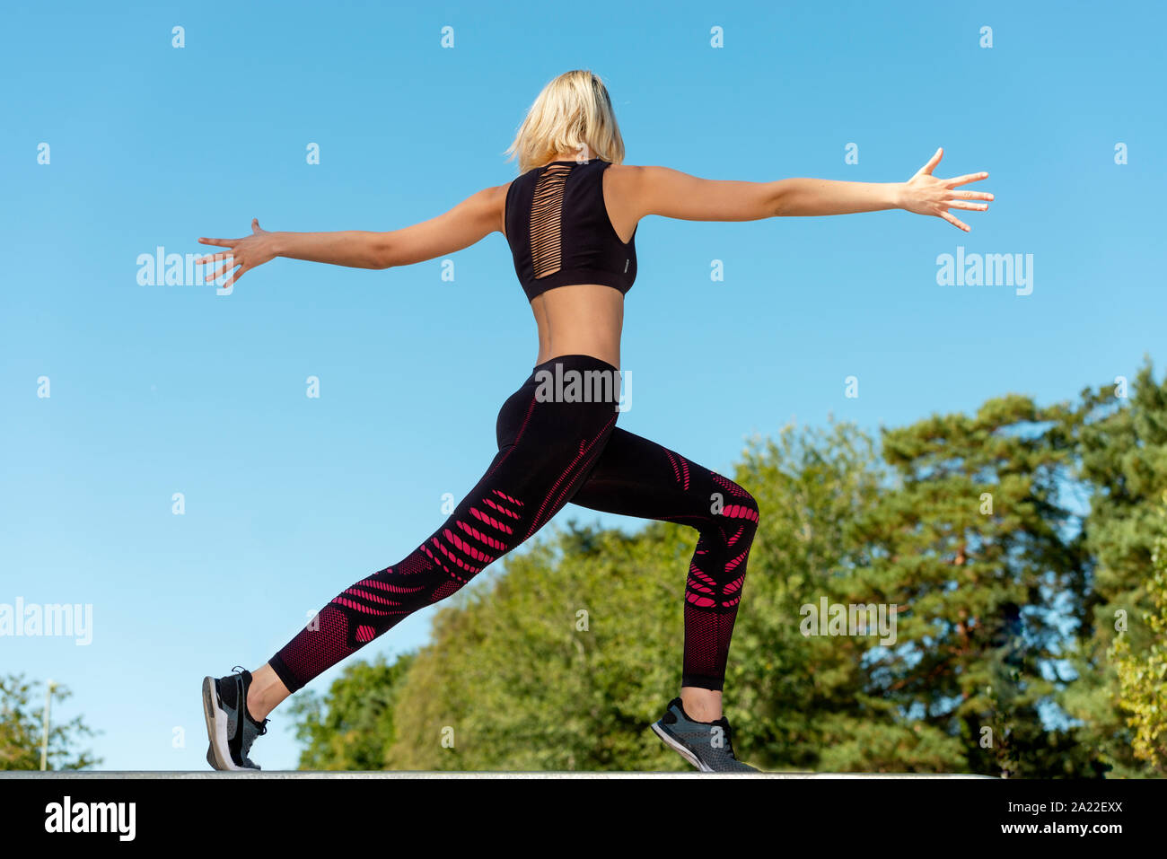 back view of a woman outdoors doing stretching exercises Stock Photo ...