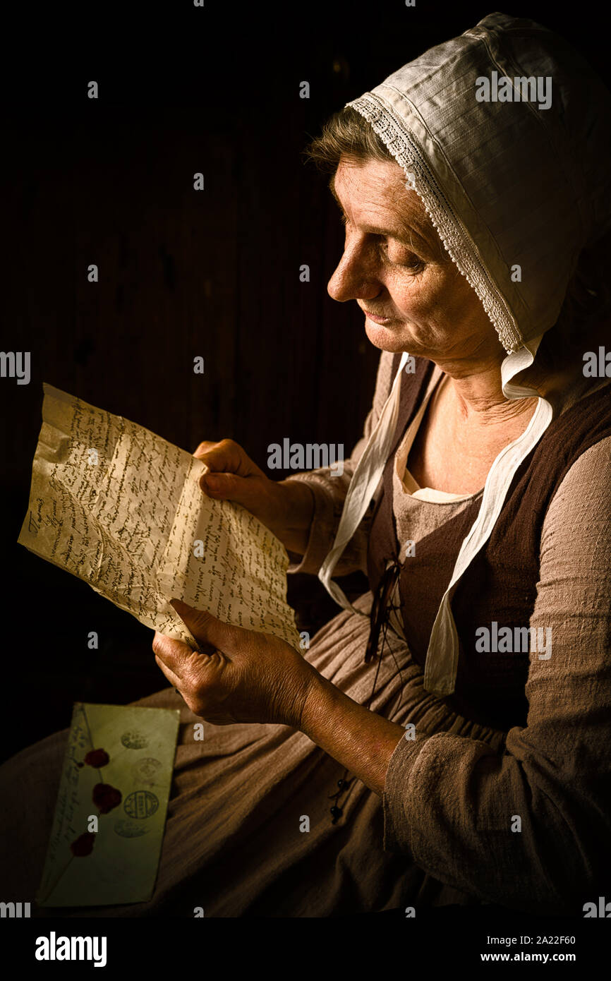 Portrait of a ature woman reading in an Old Master or Renaissance style Stock Photo