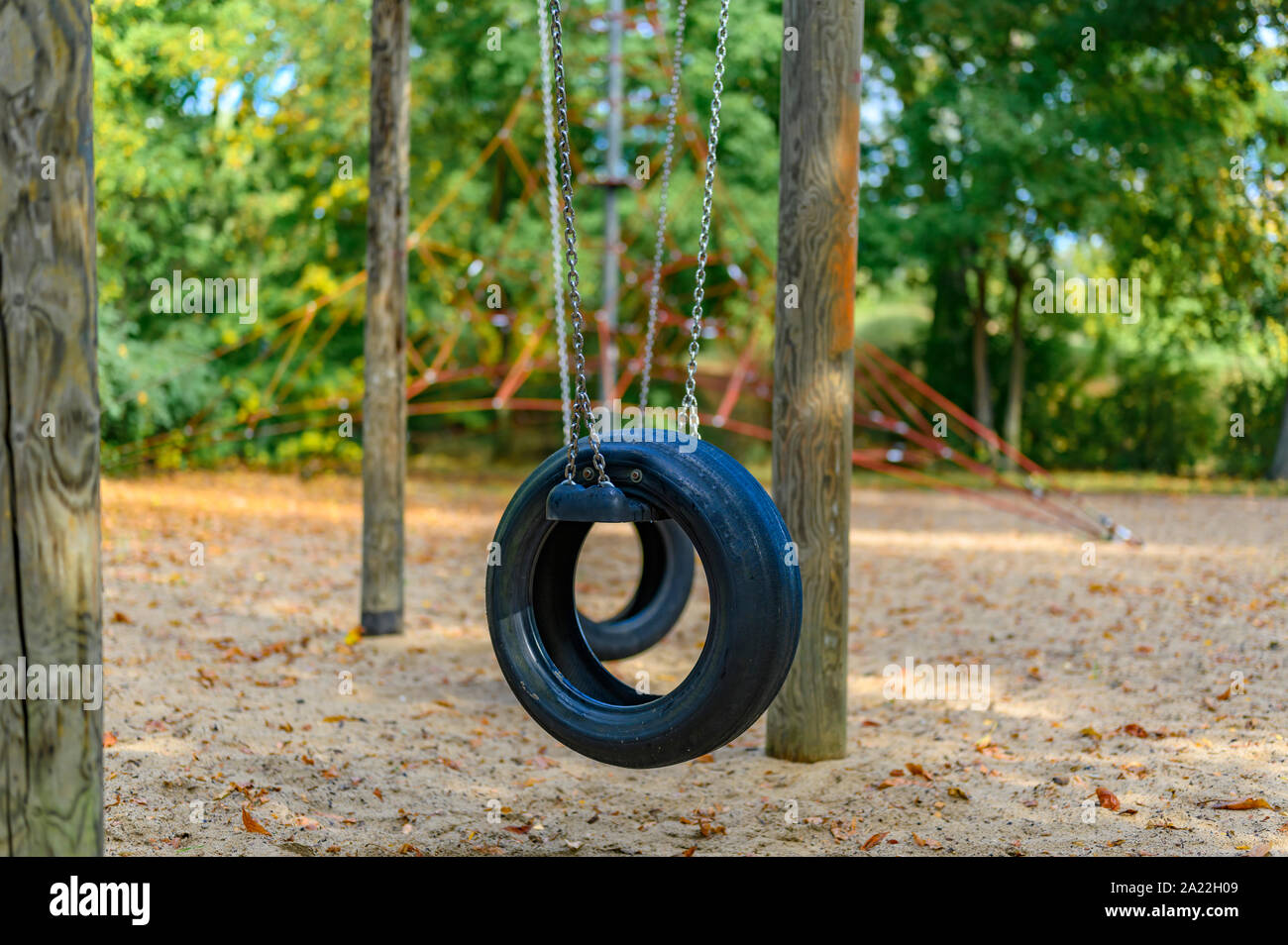 Children's playground in Germany with a tire swing and a climbing frame in  the background Stock Photo - Alamy