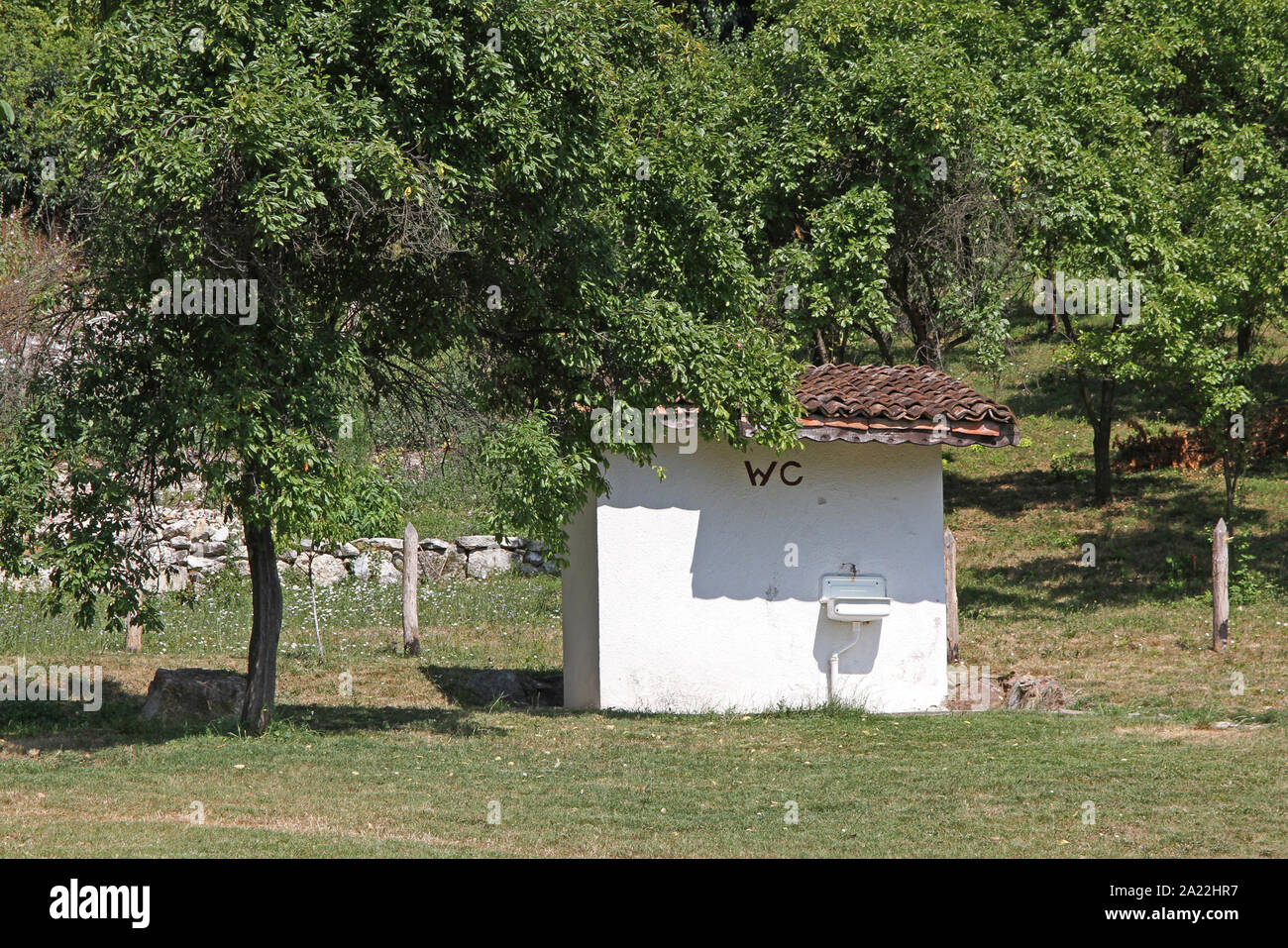 Small isolated outdoor toilet and/or bathroom near the entrance of