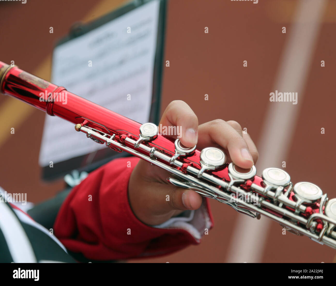 Flute player at a marching band at a high school football game Stock Photo