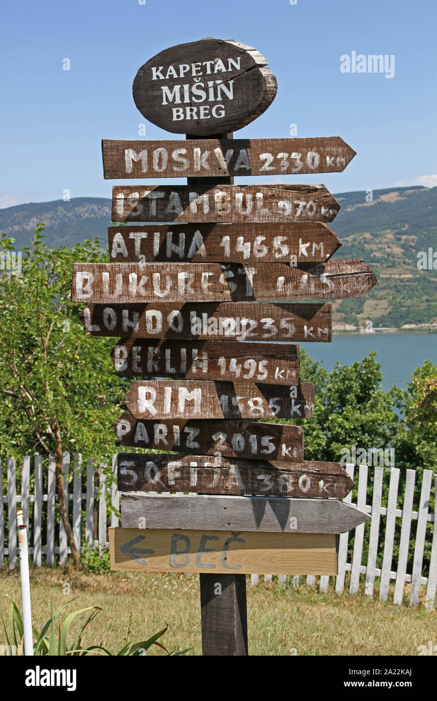 Sign with distance to 10 destinations on the Serbian bank of the Danube River on Captain Misha Hill Eco-Gallery, Karapacos, Lower Milanovac, Serbia. Stock Photo