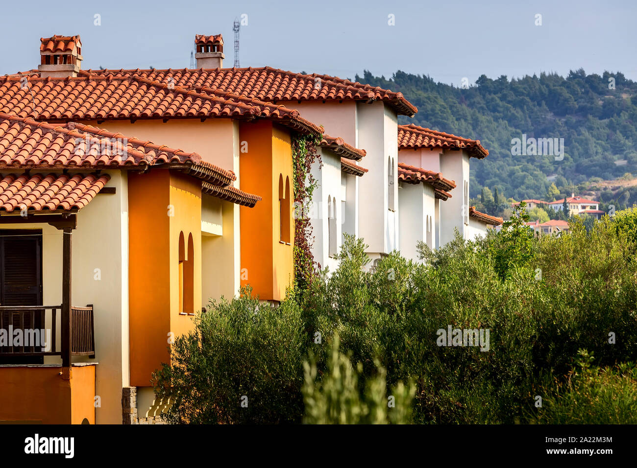 Nikiti, Sithonia, Chalkidiki Peninsula, Greece panorama with row of red  roof houses, olive garden and mountains Stock Photo - Alamy