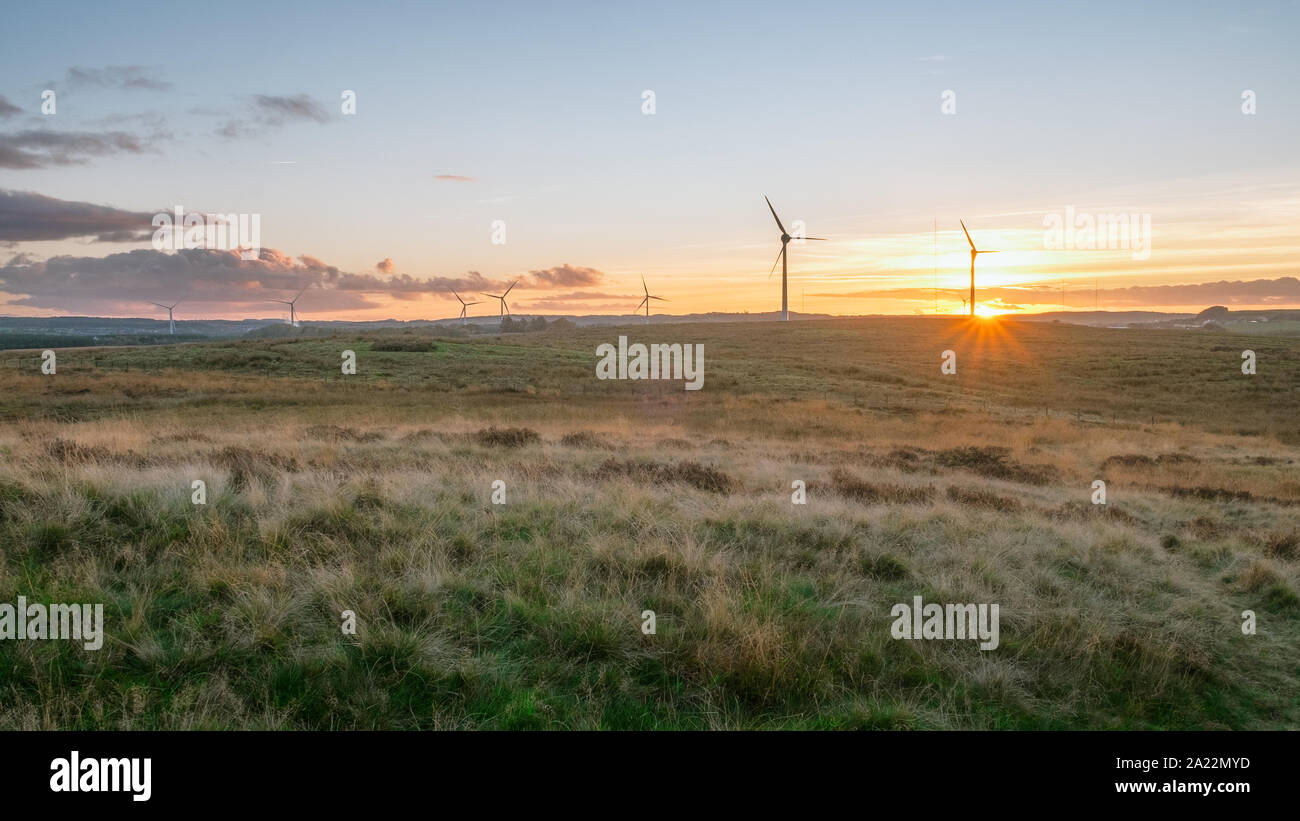 Panorama of the Scottish summer countryside with a windmills on sunset. West Lothian, Scotland Stock Photo