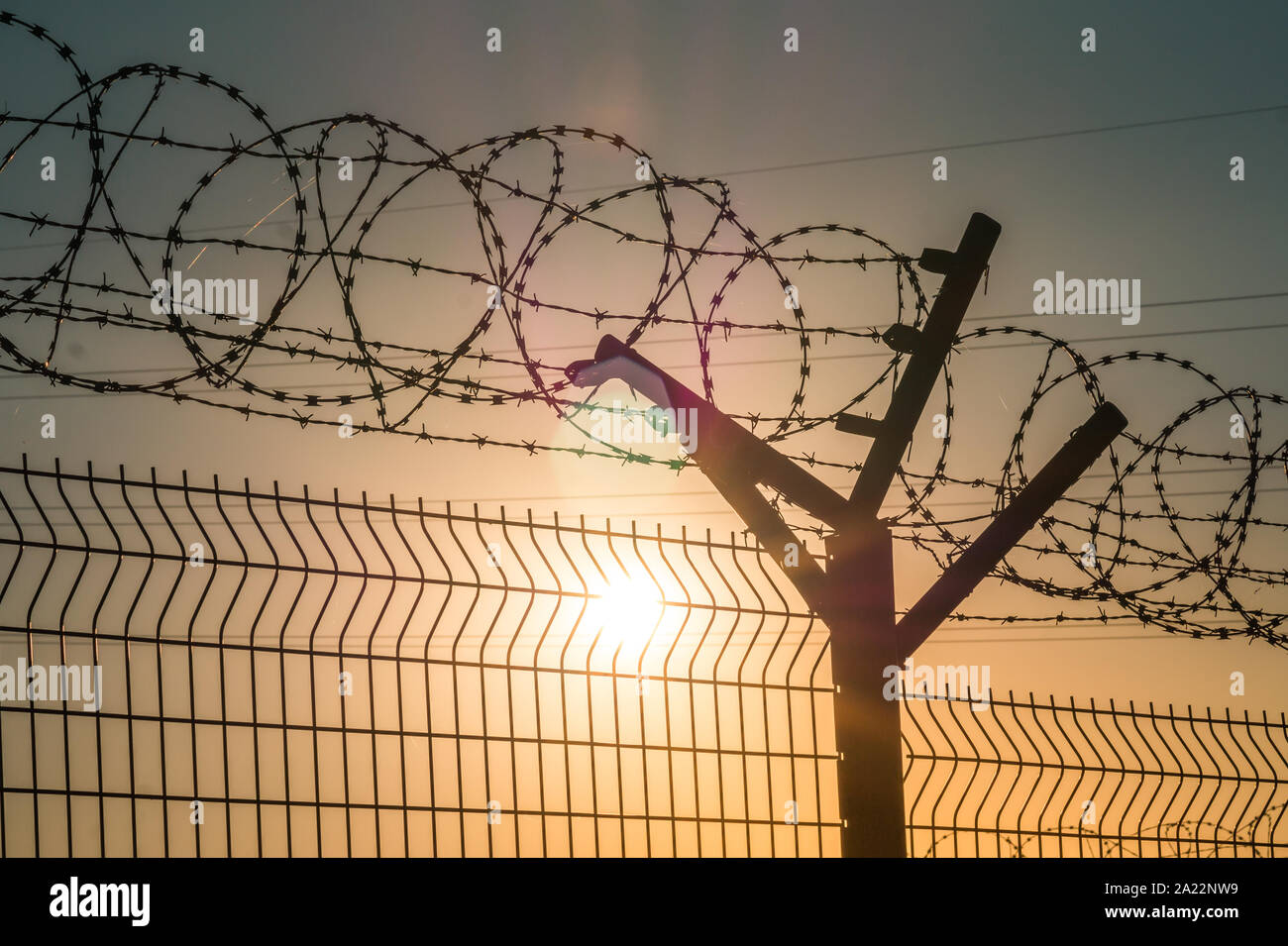 Barbed wire steel fence against the immigration in europe. Restricted area. Stock Photo