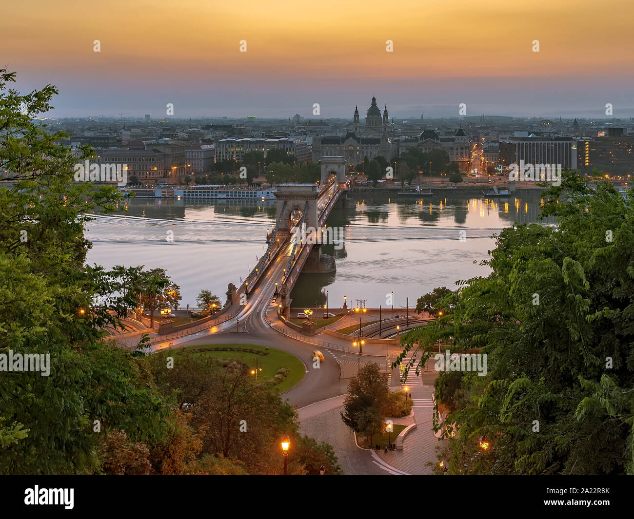 Chain bridge in Budapest, Hungary. Danube river with boats. Evening traffic with light trails. Aerial cityscape. Stock Photo