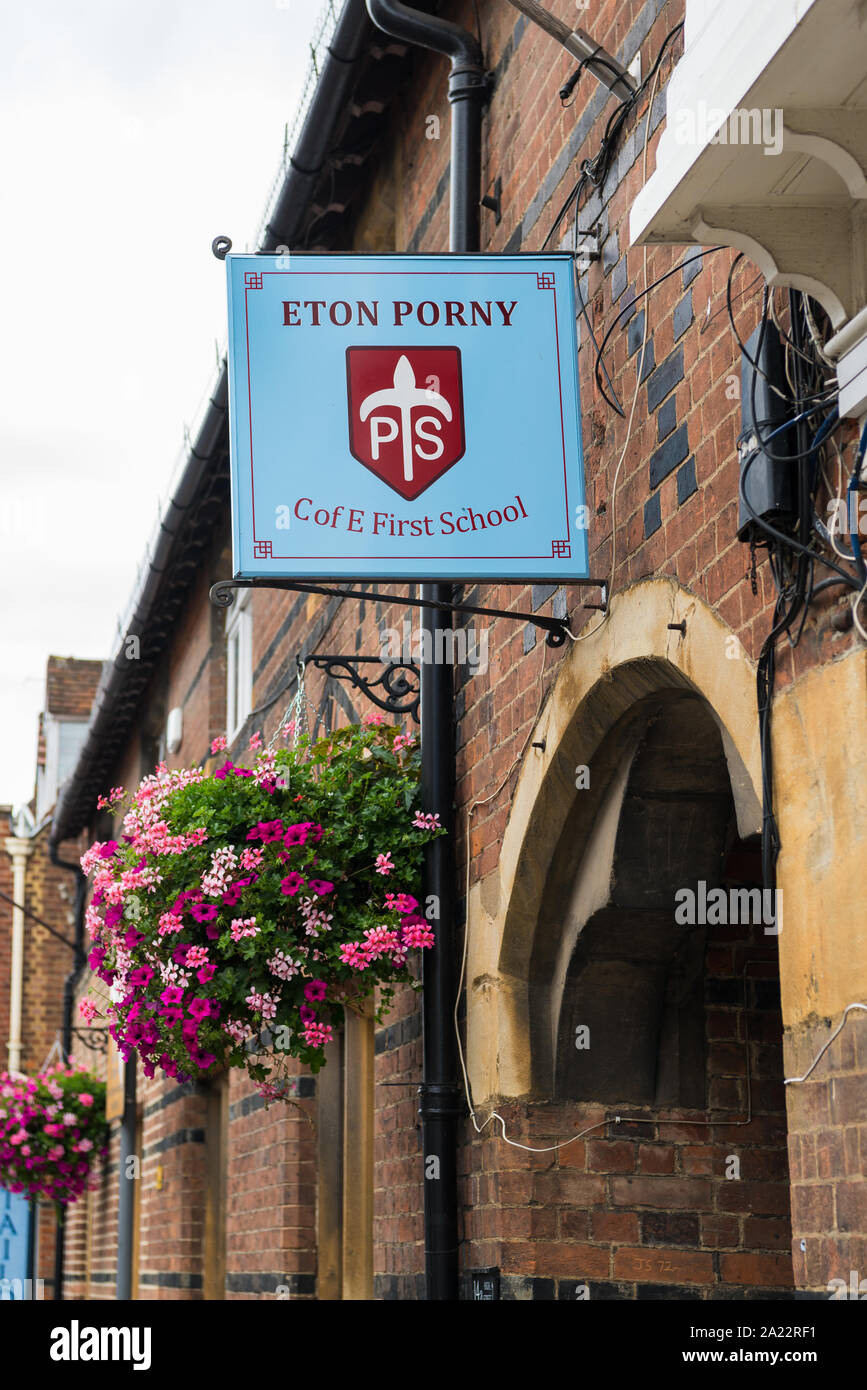 Name board on wall above the entrance to the Eton Porny Church of England First School in the High Street, Eton, Berkshire, England, UK Stock Photo