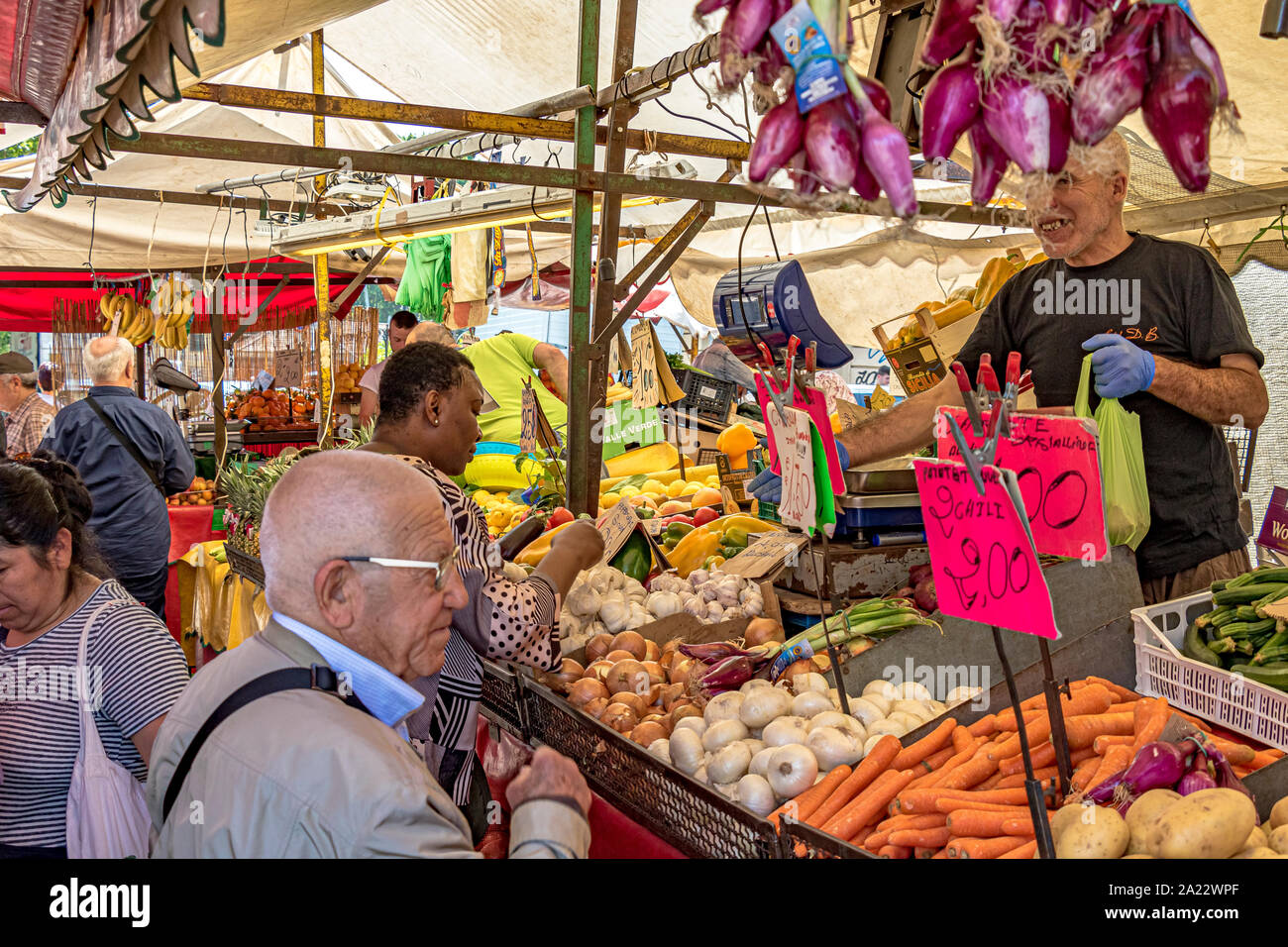 People shopping at Mercato di Porta Palazzo ,one of the largest open air markets in Europe selling a huge variety of fresh produce ,Turin ,Italy Stock Photo