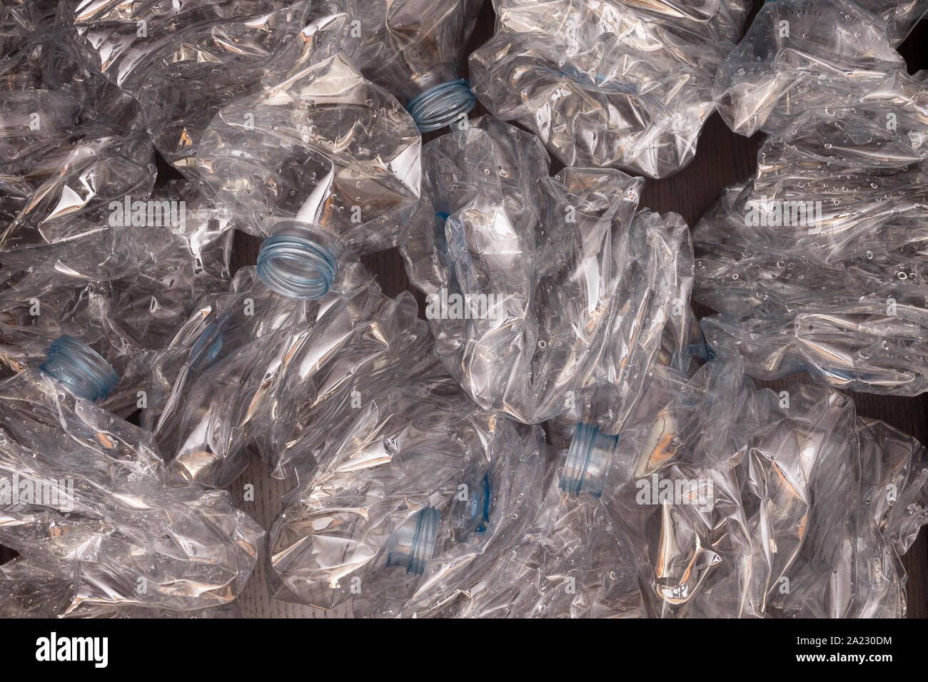 Plastic bottles background. Empty bottles on black surface. Non biodegradable waste Stock Photo