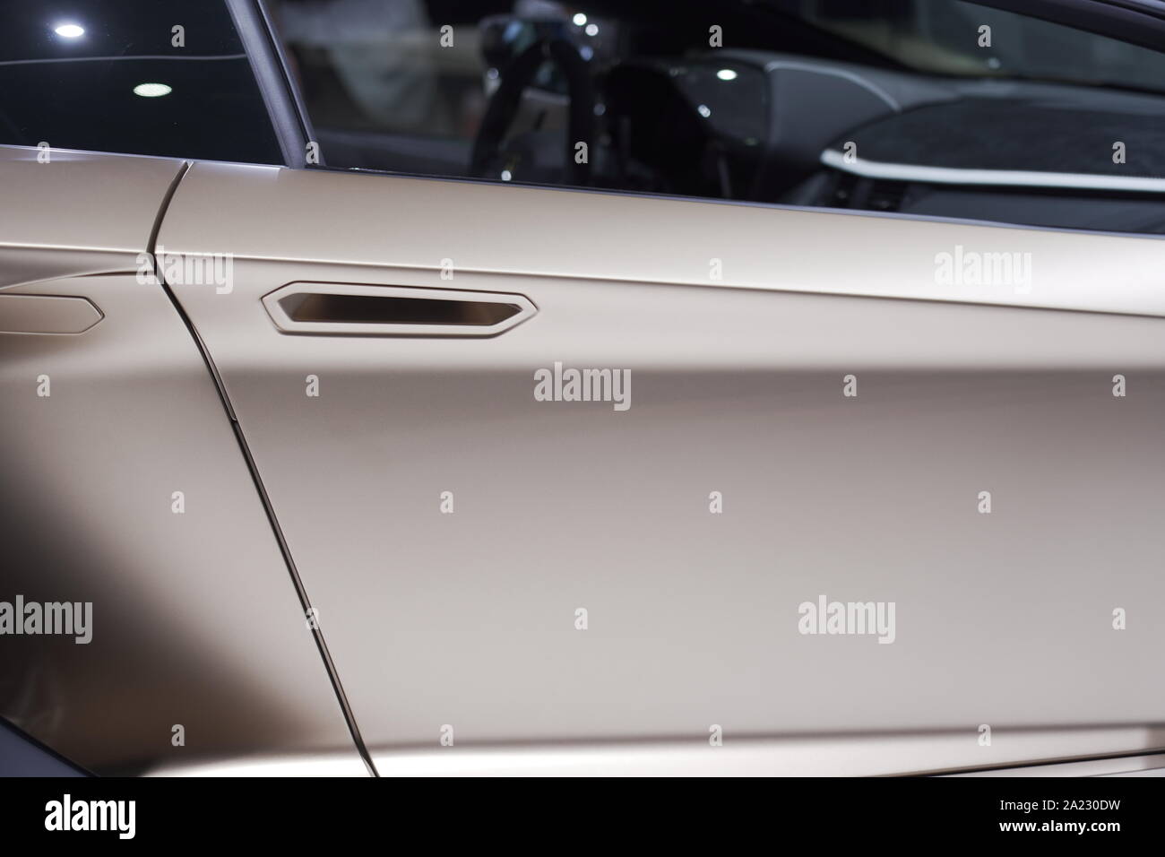 Metallic rose gold varnish car door with handle and window part as closeup at Autosalon Genf 2019 in Geneva, Switzerland Stock Photo