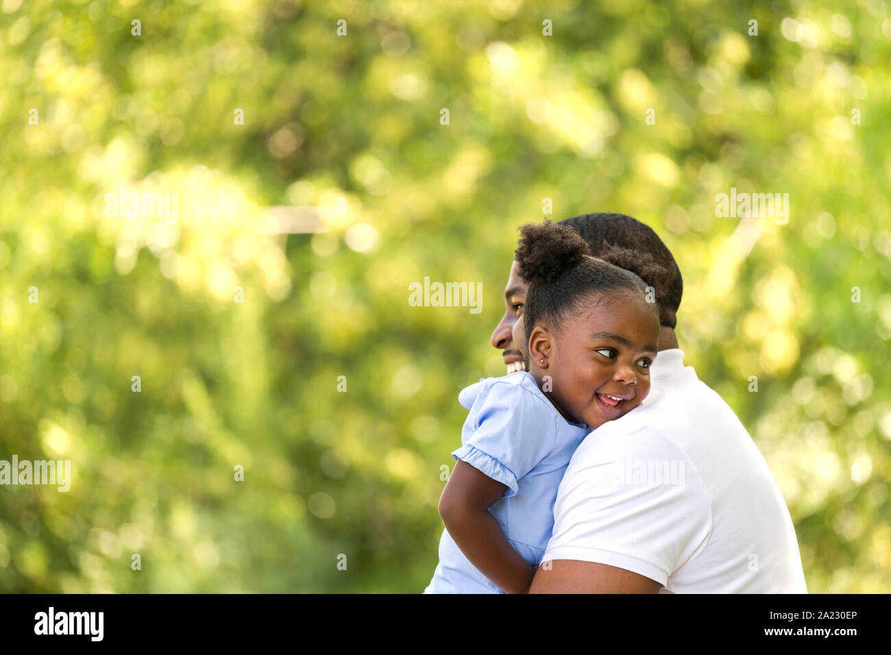 African American father hugging and holding his little girl Stock Photo ...