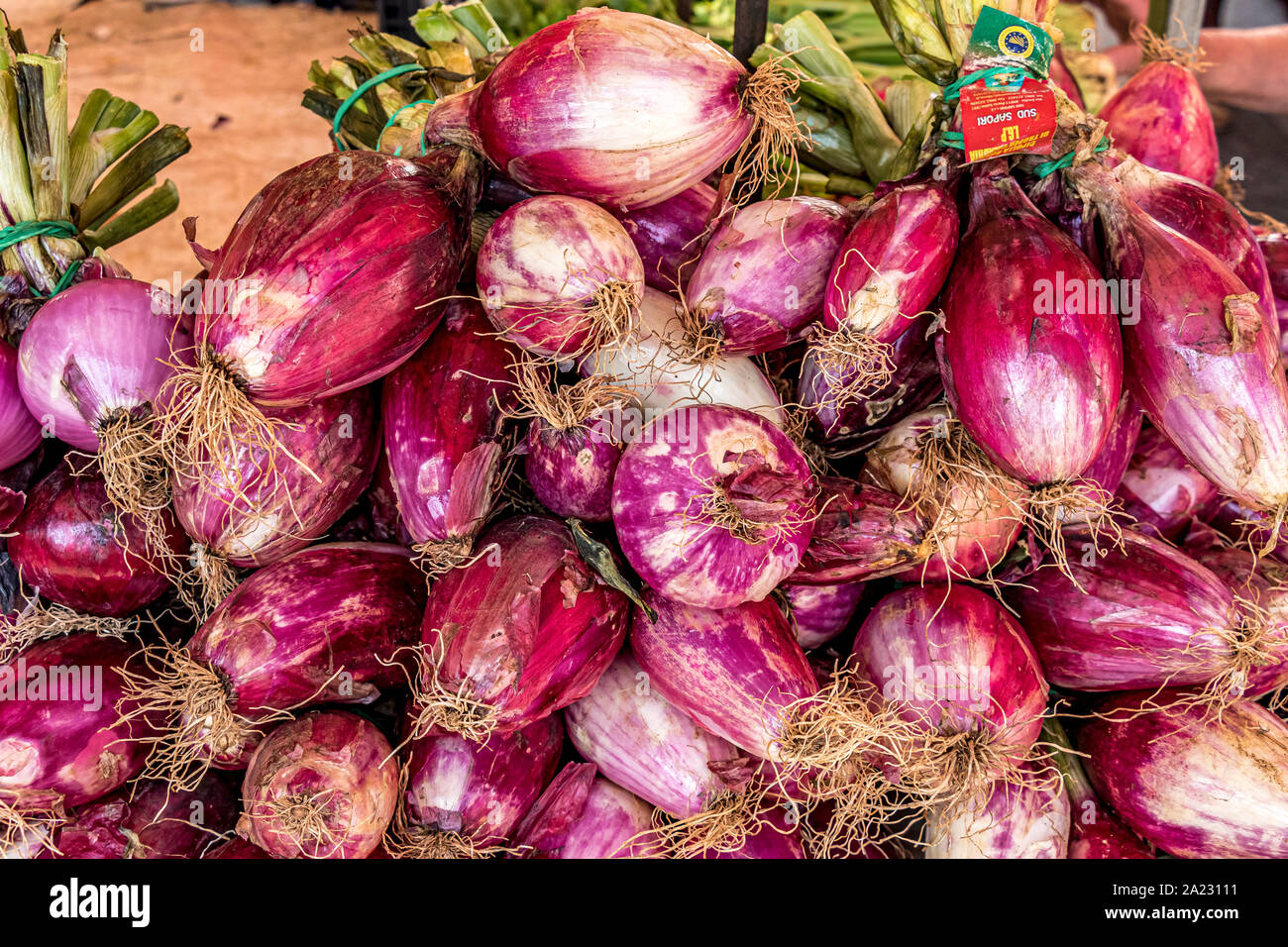 Red onions on a stall at Mercato di Porta Palazzo ,a large open air market in Europe selling a huge variety of fresh produce ,Turin ,Italy Stock Photo