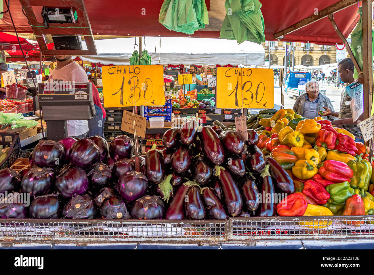 Aubergines and peppers on a stall at Mercato di Porta Palazzo ,a large open air market in Europe selling a huge variety of fresh produce ,Turin ,Italy Stock Photo